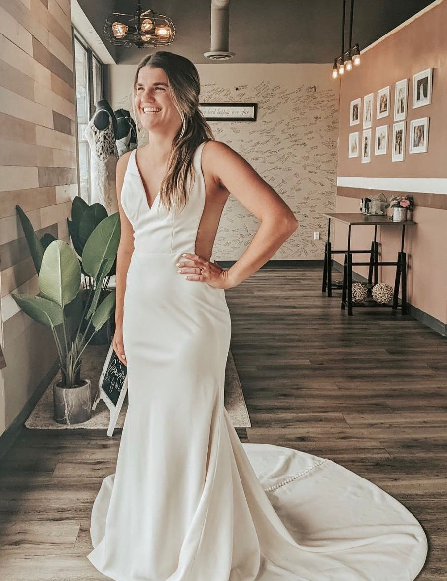 Colonnel - fitted and refined modern wedding dress with thin straps and transparent openings on the sides Colonnel - fitted and refined modern wedding dress with thin straps and transparent openings on the sides