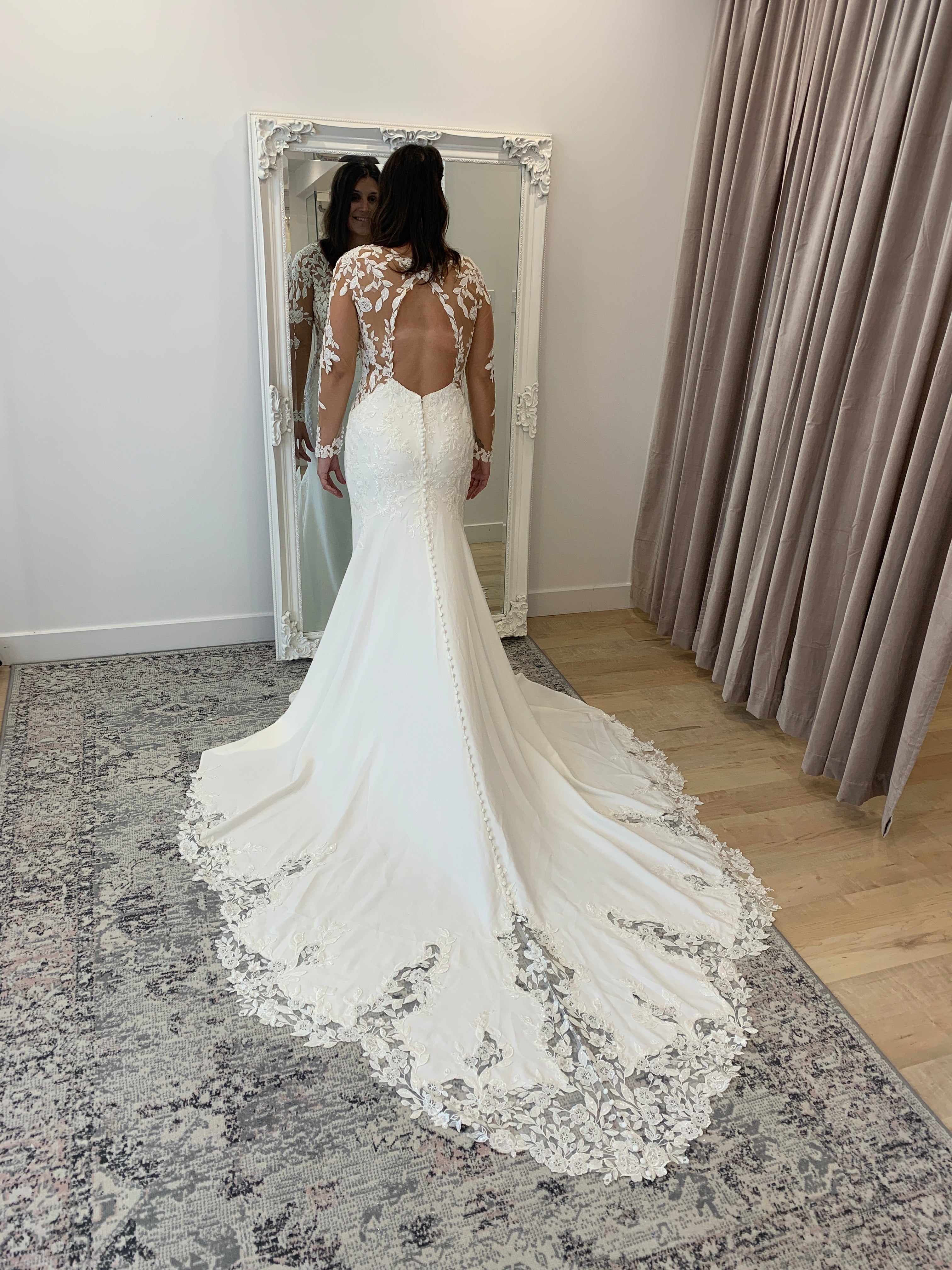 Austina - slim fit wedding dress with long sleeves in embroidered lace with crepe bottom and lace insert in the train Austina - slim fit wedding dress with long sleeves in embroidered lace with crepe bottom and lace insert in the train