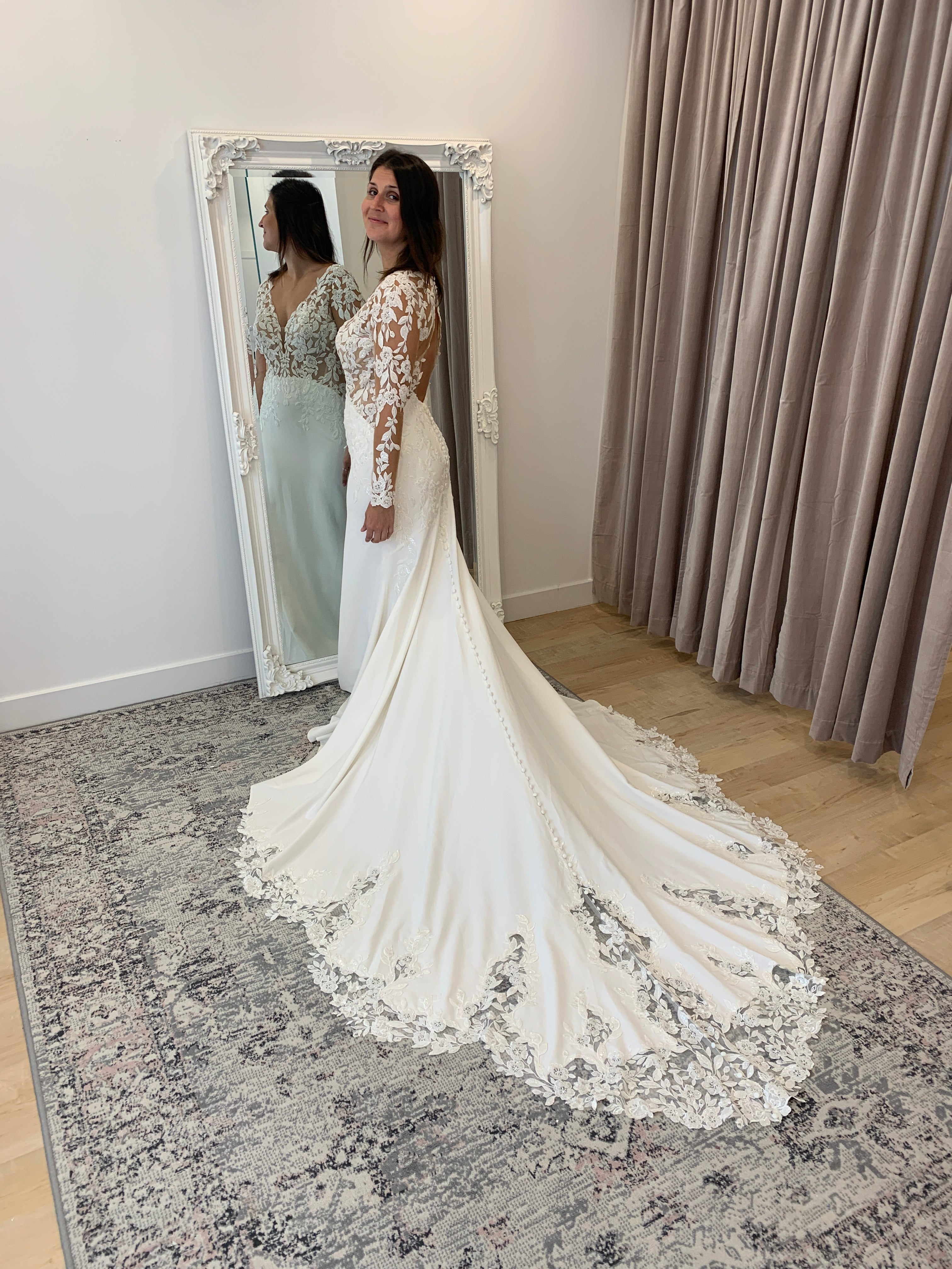 Austina - slim fit wedding dress with long sleeves in embroidered lace with crepe bottom and lace insert in the train Austina - slim fit wedding dress with long sleeves in embroidered lace with crepe bottom and lace insert in the train