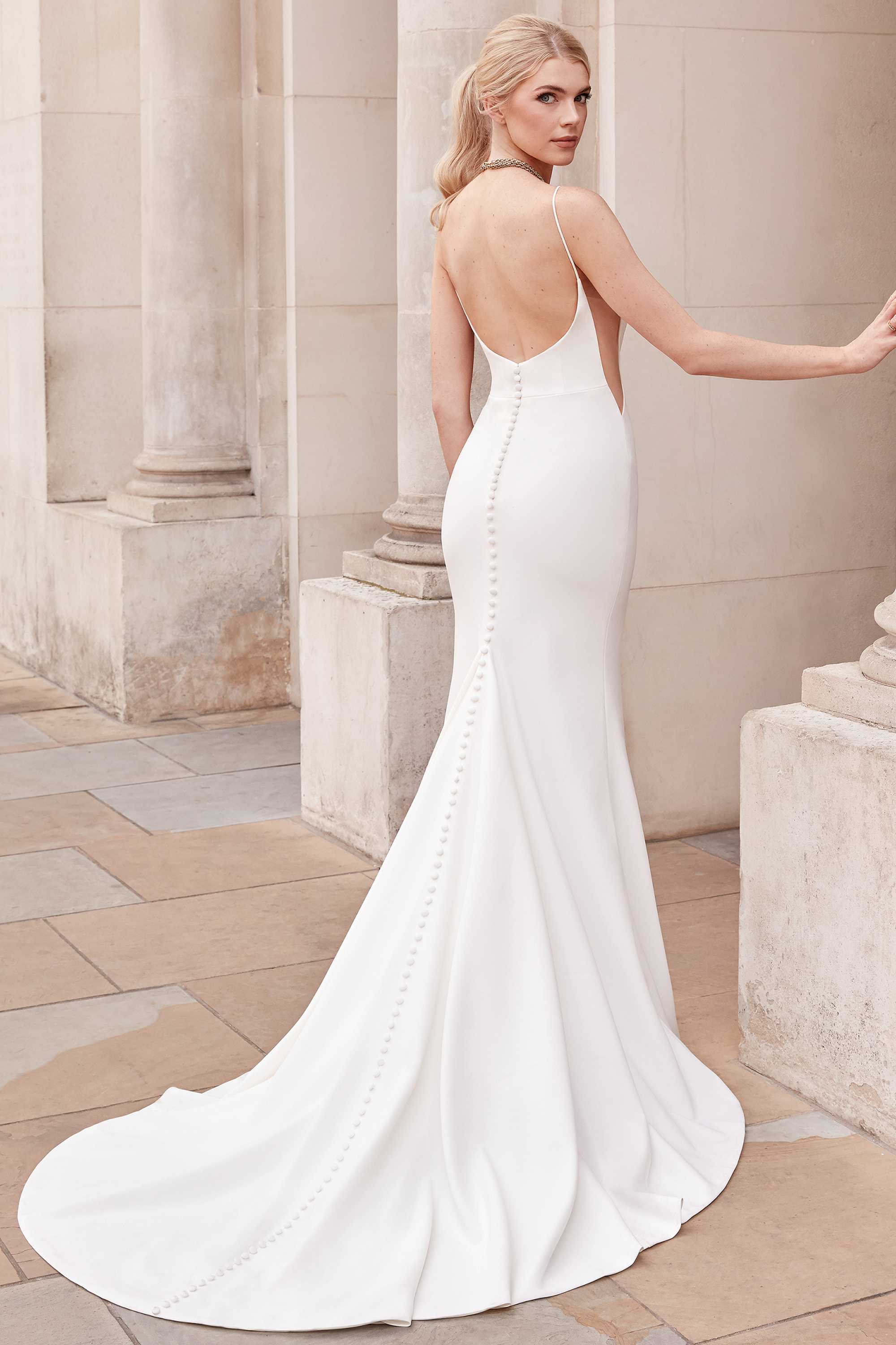 Colonnel - fitted and refined modern wedding dress with thin straps and transparent openings on the sides Colonnel - fitted and refined modern wedding dress with thin straps and transparent openings on the sides