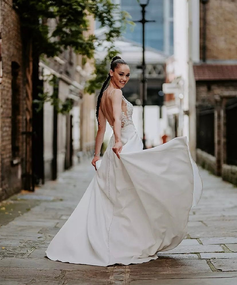 Ranger - robe de mariée classique à décolleté plongeant illusion en dentelle et jupe en satin mât avec poches Ranger - robe de mariée classique à décolleté plongeant illusion en dentelle et jupe en satin mât avec poches