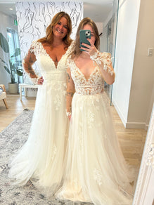 Cayla *taille plus* - robe de mariée boho en tulle à manches longues avec taille cintrée et dentelle d’inspiration végétale